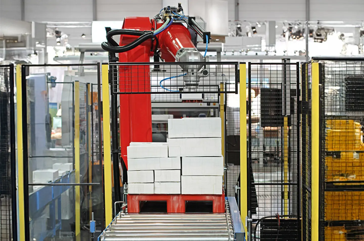 Industrieel transportsysteem in een fabriek met veiligheidsbarrières en waarschuwingsstrepen op de vloer