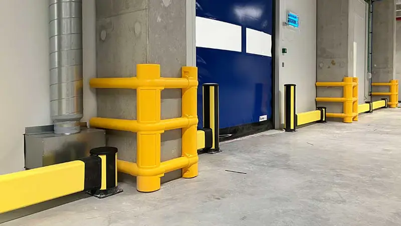 yellow column guards around a upright column and impact protection installed in a dispatch area