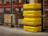 yellow and black column guard protecting pillar in industrial environment